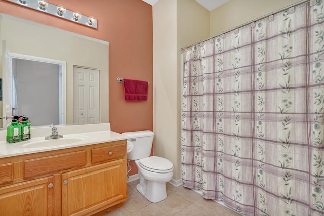 bathroom with tile patterned flooring, vanity, and toilet