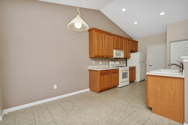 kitchen featuring white appliances, hanging light fixtures, lofted ceiling, and sink