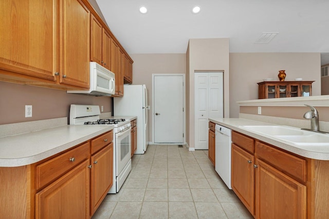 kitchen featuring white appliances and sink