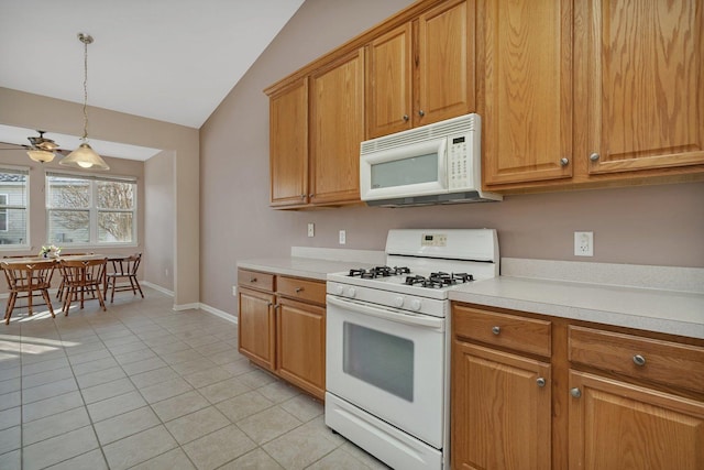 kitchen with ceiling fan, hanging light fixtures, lofted ceiling, white appliances, and light tile patterned floors