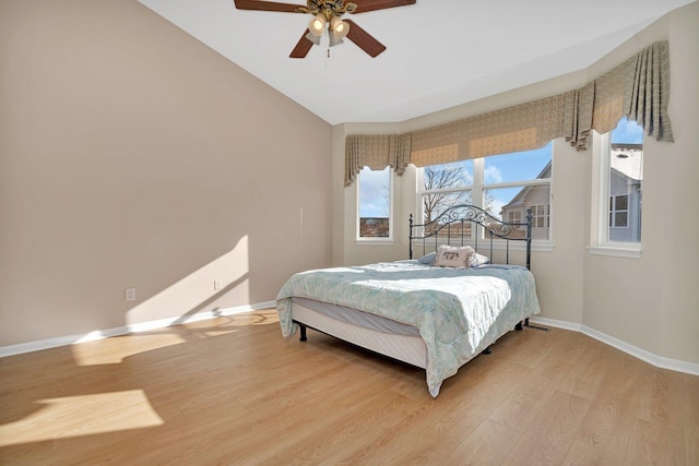 bedroom with light hardwood / wood-style flooring, ceiling fan, and lofted ceiling