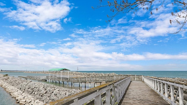 surrounding community with a water view and a view of the beach