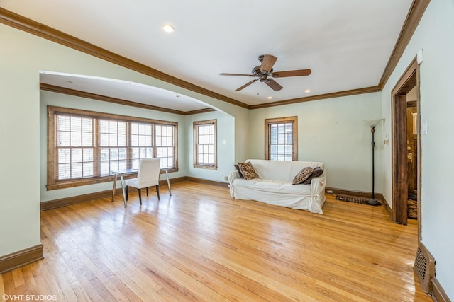 unfurnished living room with light wood-type flooring, ceiling fan, and ornamental molding