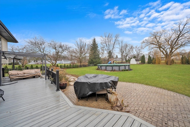 deck with a lawn and a covered pool