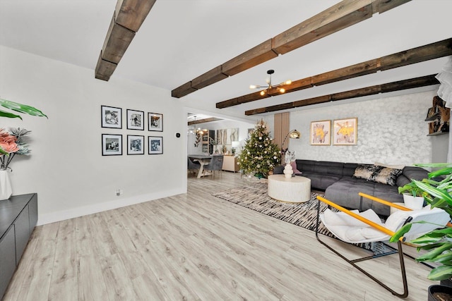 living room featuring beamed ceiling, a notable chandelier, and light hardwood / wood-style floors