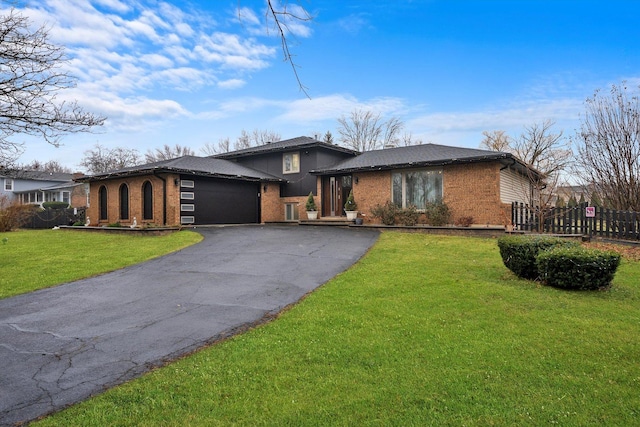 view of front of house with a garage and a front yard