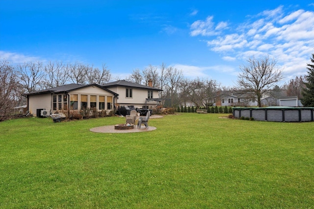 view of yard featuring a sunroom and a patio