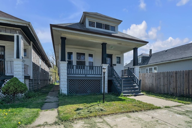 bungalow-style home with a porch and a front yard