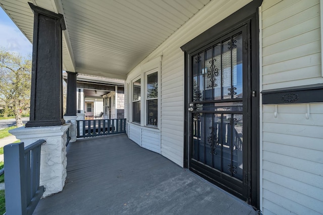 view of exterior entry with a porch