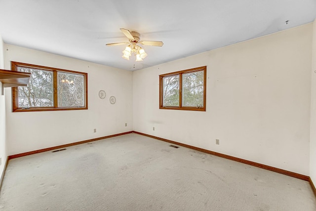 carpeted empty room featuring ceiling fan