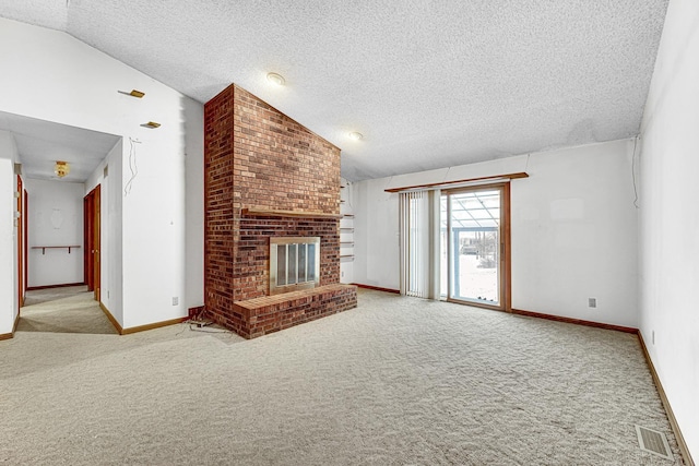 unfurnished living room featuring lofted ceiling, a brick fireplace, a textured ceiling, and light carpet