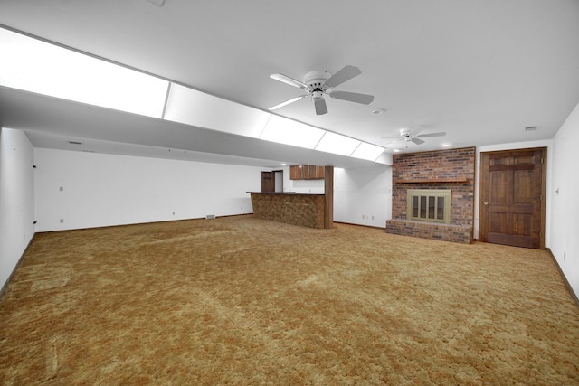 unfurnished living room with lofted ceiling, a fireplace, carpet floors, and ceiling fan