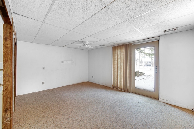 carpeted spare room with a drop ceiling and ceiling fan