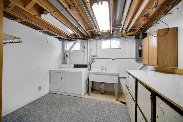 clothes washing area with washing machine and clothes dryer and light colored carpet