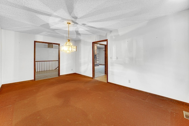 unfurnished room featuring carpet floors and a textured ceiling