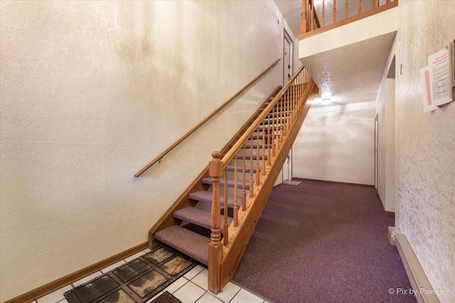 stairs with a towering ceiling and tile patterned floors