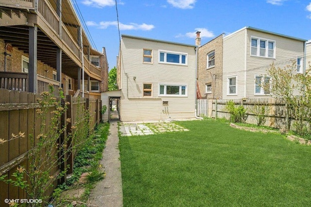 rear view of property featuring a yard