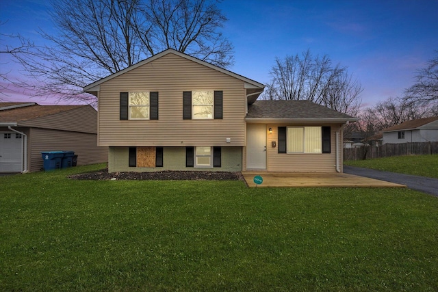 split level home featuring a lawn