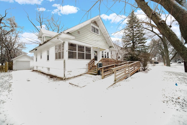 view of front of property with an outbuilding, a sunroom, and a garage