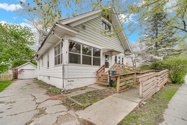 1009 Augusta Ave, Elgin, IL 60120 - bungalow-style home featuring driveway, an outdoor structure, and a detached garage