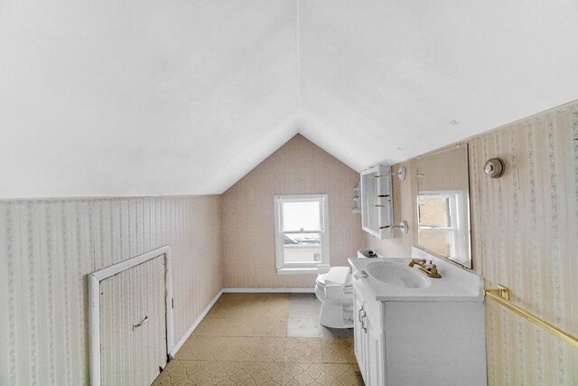1009 Augusta Ave, Elgin, IL 60120 - bathroom featuring lofted ceiling, toilet, vanity, wallpapered walls, and tile patterned floors