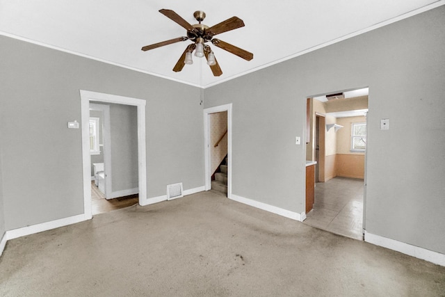 1009 Augusta Ave, Elgin, IL 60120 - carpeted spare room with ceiling fan, crown molding, baseboards, and stairs