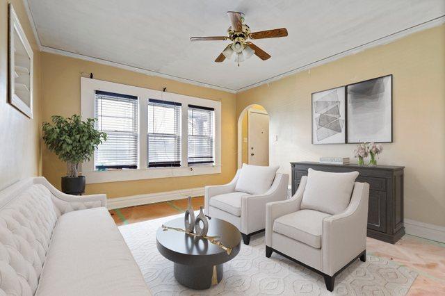 interior space featuring ceiling fan and crown molding