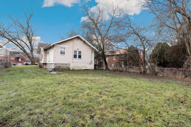 view of side of home featuring a lawn