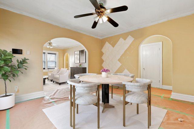 dining room with ceiling fan and crown molding