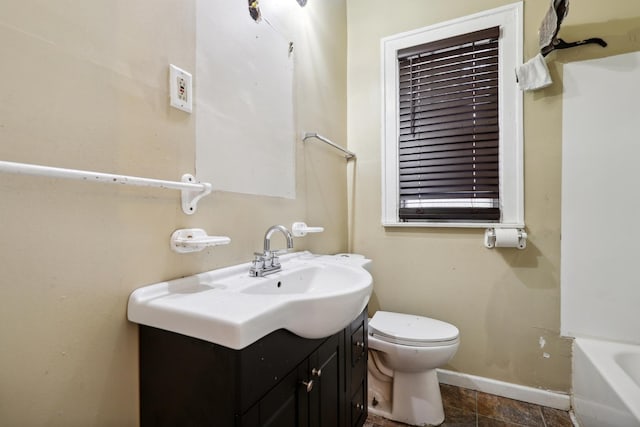 bathroom with a bathing tub, vanity, and toilet