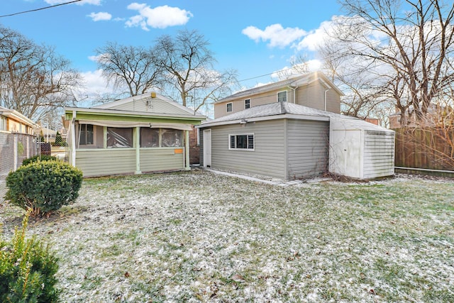 back of house featuring an outbuilding