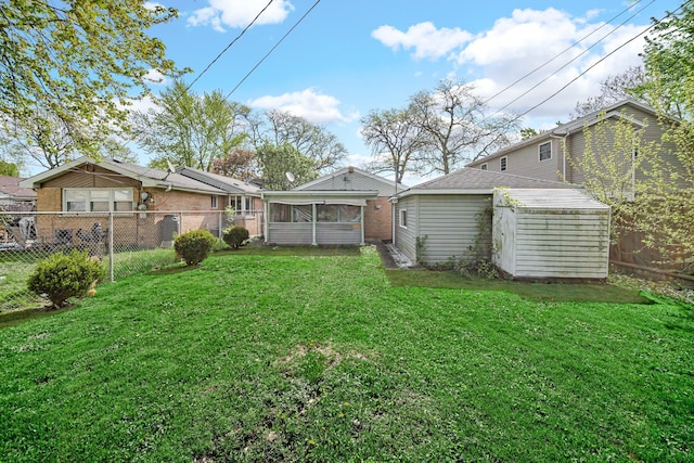 view of yard featuring a sunroom, an outbuilding, and a shed