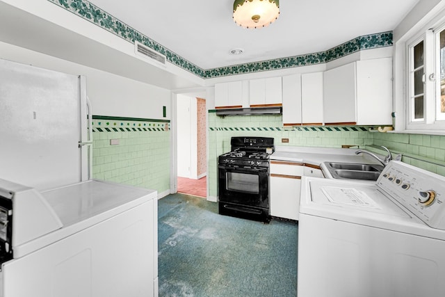 washroom with independent washer and dryer and sink