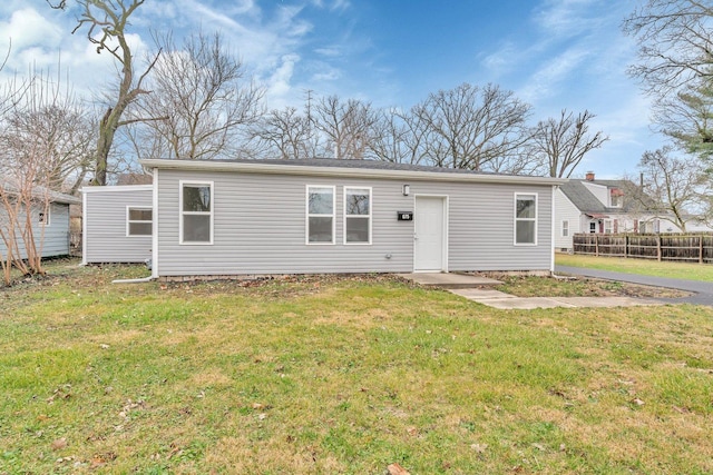 back of property featuring a yard