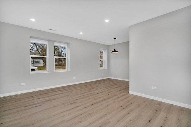 spare room with light hardwood / wood-style floors