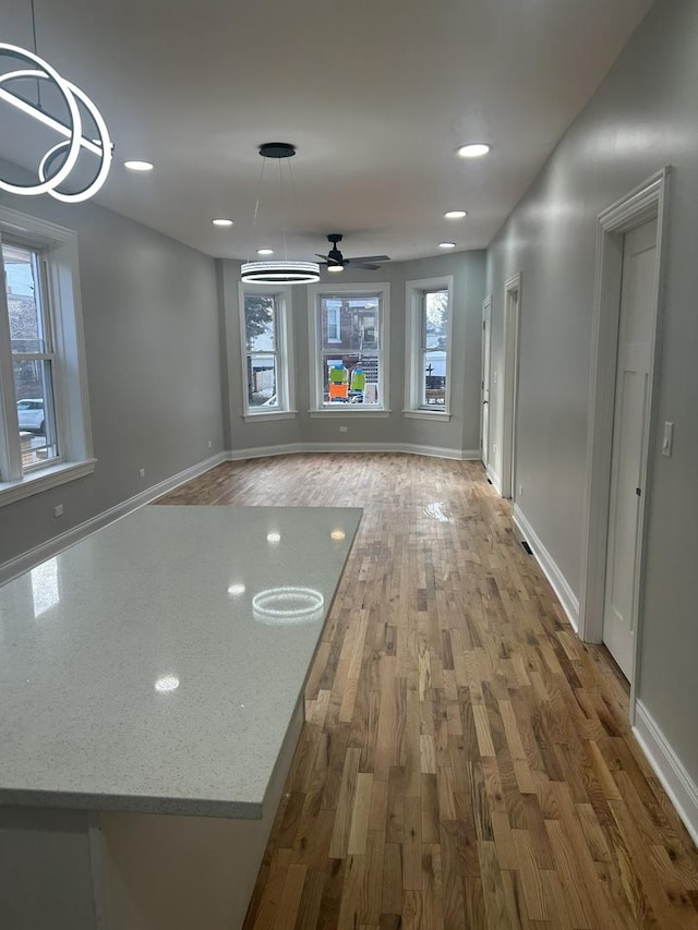 interior space featuring recessed lighting, wood finished floors, and baseboards