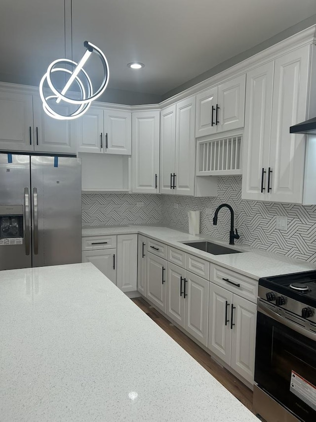 kitchen with white cabinets, appliances with stainless steel finishes, and a sink