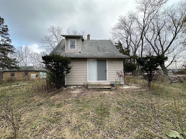 back of house with an outbuilding