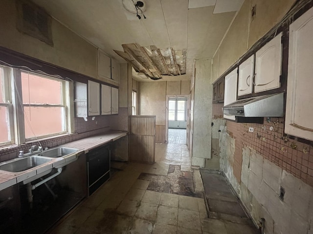 kitchen featuring decorative backsplash, tile counters, and sink