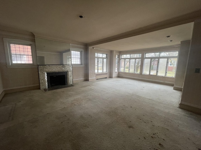 unfurnished living room featuring beam ceiling and light colored carpet