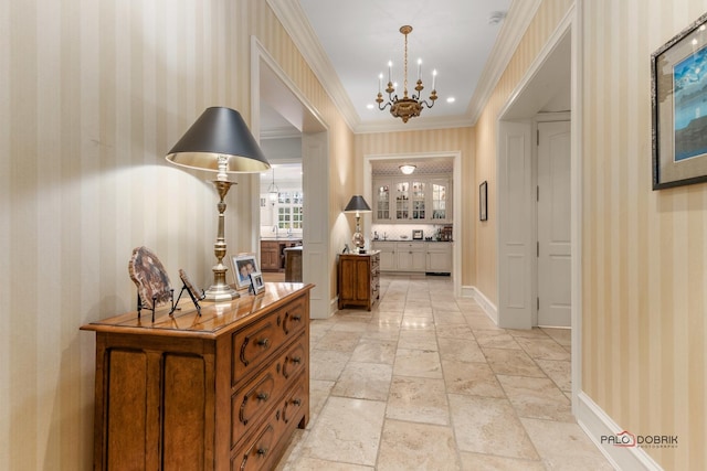 corridor with crown molding and a chandelier