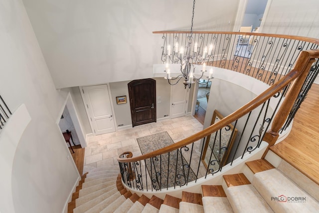 stairs featuring a notable chandelier