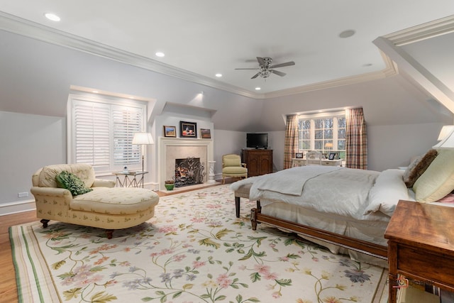 bedroom with ceiling fan, light hardwood / wood-style flooring, vaulted ceiling, and crown molding