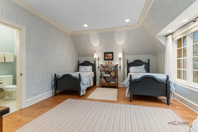 bedroom with ensuite bathroom, vaulted ceiling, crown molding, and light hardwood / wood-style flooring