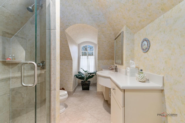 bathroom with toilet, tile patterned floors, vanity, a shower with door, and lofted ceiling