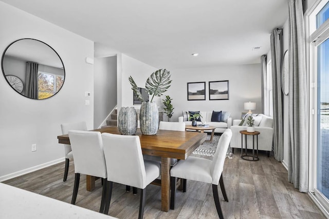 dining space with hardwood / wood-style flooring