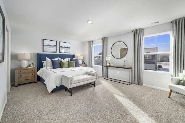 carpeted bedroom with multiple windows