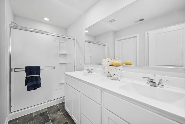 bathroom featuring vanity and a shower with door