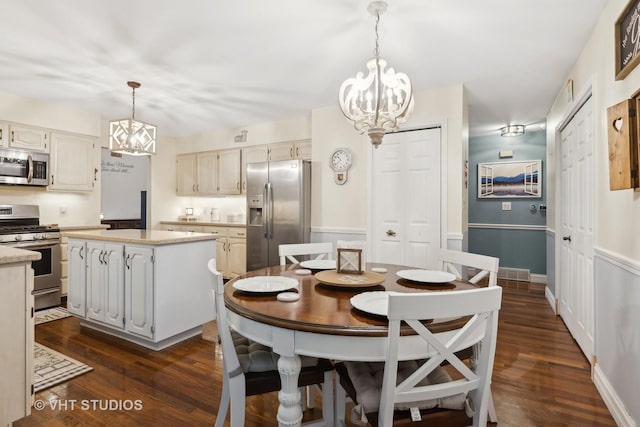 dining space featuring dark hardwood / wood-style flooring and a notable chandelier