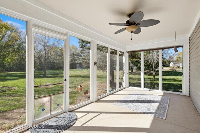 unfurnished sunroom featuring ceiling fan